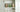 Neatly organized kitchen cabinet with various food items in jars and containers on shelves