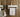 A small bathroom with a sink, toilet and wall-mounted towel rack